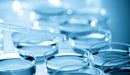 Pipette adding fluid to one of several test tubes